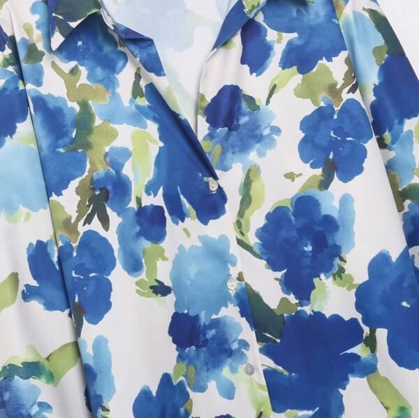 the upper part and buttons of colorful blouse with blue flowers