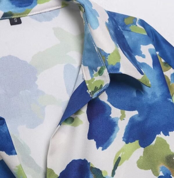 the collar of colorful blouse with blue flowers