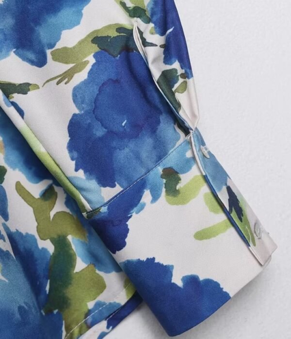 material and sleeve of colorful blouse with blue flowers