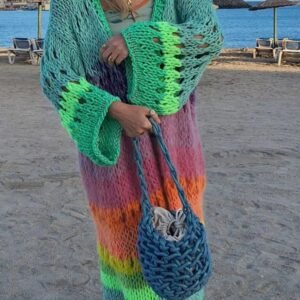 woman wearing colorful Bohemian cardigan and holding a blue bag