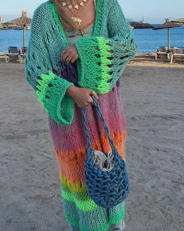 woman wearing colorful Bohemian cardigan and holding a blue bag