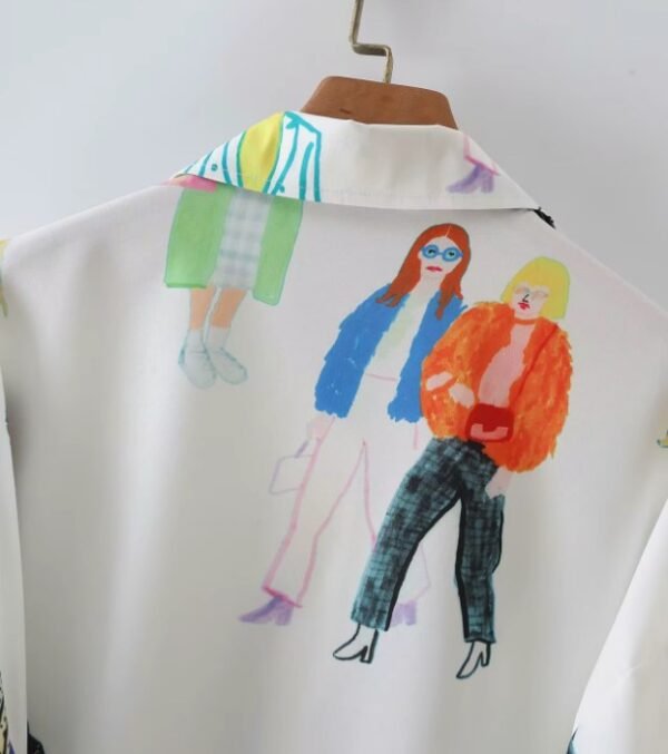 back view of upper part of colorful characters blouse on a hanger