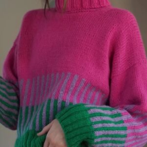 woman turned to her side wearing colorful color blocking sweater