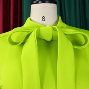 bow of green colorful dress with a bow on a mannequin