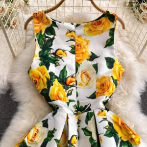 upper part of colorful dress with yellow roses on a white fluffy carpet