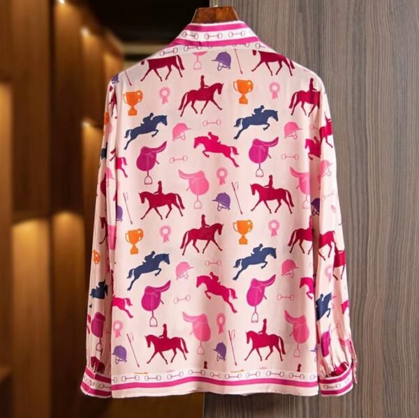 back side of colorful horse blouse on a hanger