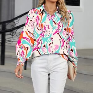 woman walking in colorful long-sleeved blouse and holdig a beige purse