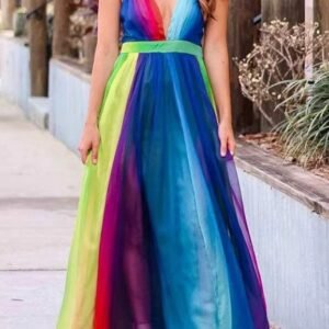 woman standing in colorful prom dress, a concrete road behind her