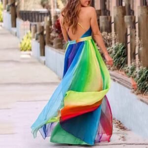 woman wearing colorful prom dress and spinning, grey street behind her