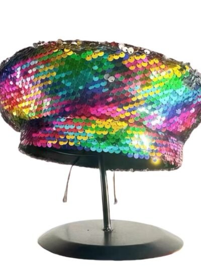 colorful sequin beret hang on a black pillar, white background