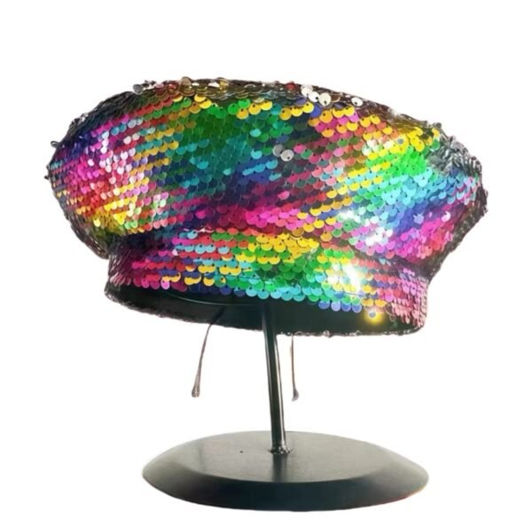 colorful sequin beret hang on a black pillar, white background