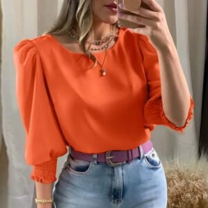 woman wearing orange colorful short sleeved blouse and jeans