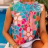 woman wearing colorful sleeveless blouse, the pool in the background