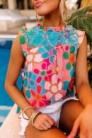 woman wearing colorful sleeveless blouse, the pool in the background