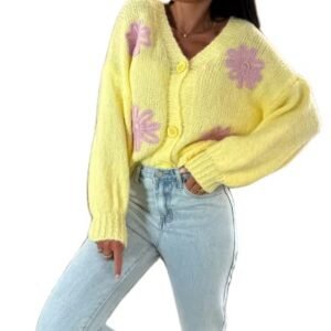 woman wearing colorful spring cardigan and bright jeans, white background