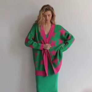 woman wrapping herself up in colorful stars cardigan, white wall in the background