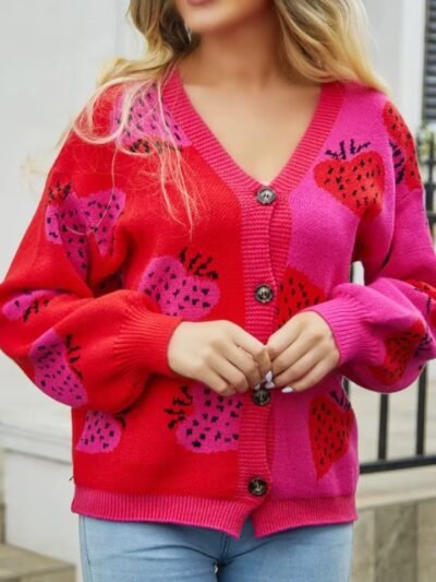 blonde woman wearing colorful strawberry cardigan and jeans