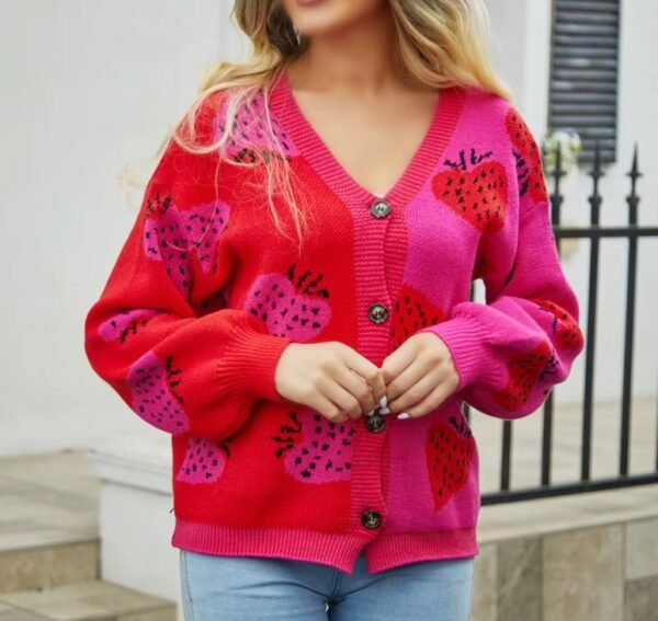 blonde woman wearing colorful strawberry cardigan and jeans