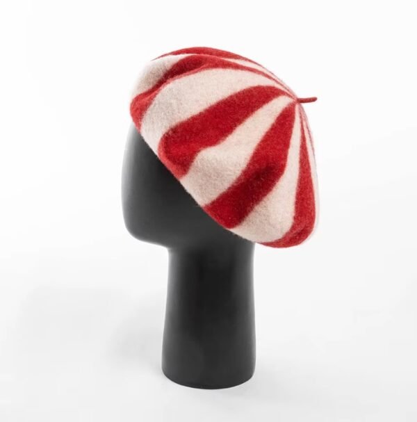 red colorful striped beret on a black mannequin, white background