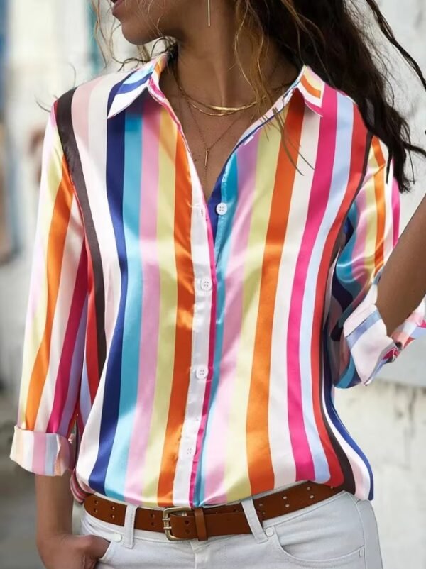 woman wearing colorful striped blouse and white jeans