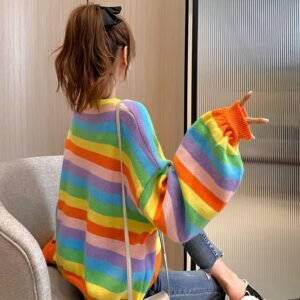 woman turned to her back wearing colorful striped sweater and a black bow in her brown hair