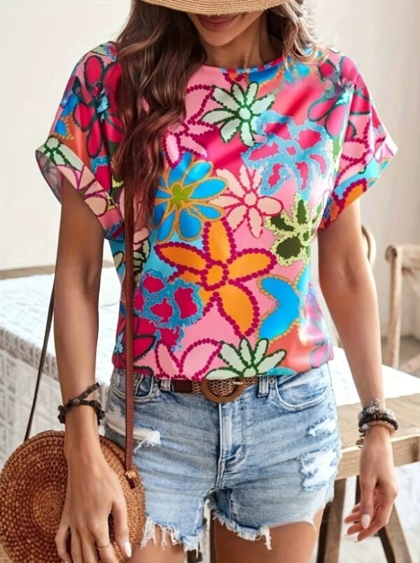 woman wearing colorful summer blouse, jeans shorts and a brown bag