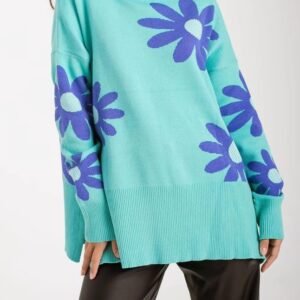 woman wearing colorful sweater with blue flowers and black leather pants