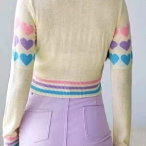 woman turned to her back wearing colorful sweater with hearts and lavender pencil skirt