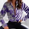 woman wearing purple colorful zebra blouse and black jeans