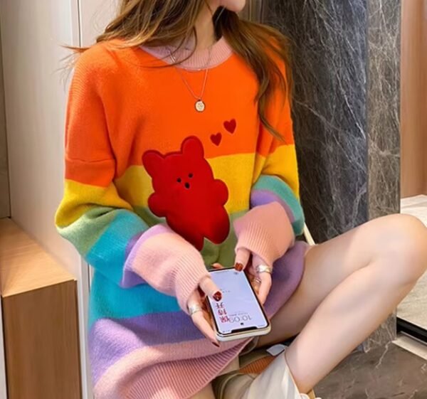 woman wearing cute colorful sweater, sitting and checking her phone