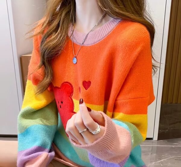 woman wearing cute colorful sweater and holding one hand up