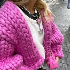 woman wearing fuchsia cardigan and a white top