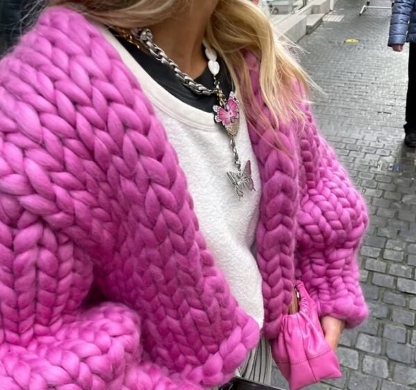 woman wearing fuchsia cardigan and a white top