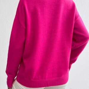 woman turned to her back wearing fuchsia sweater and white jeans