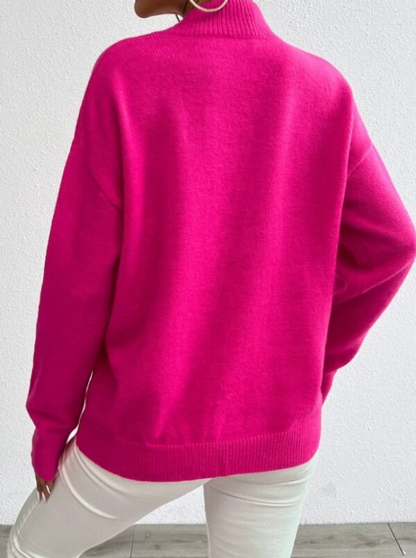 woman turned to her back wearing fuchsia sweater and white jeans