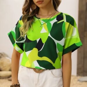 woman wearing green colorful blouse and white shorts, wooden door in the background