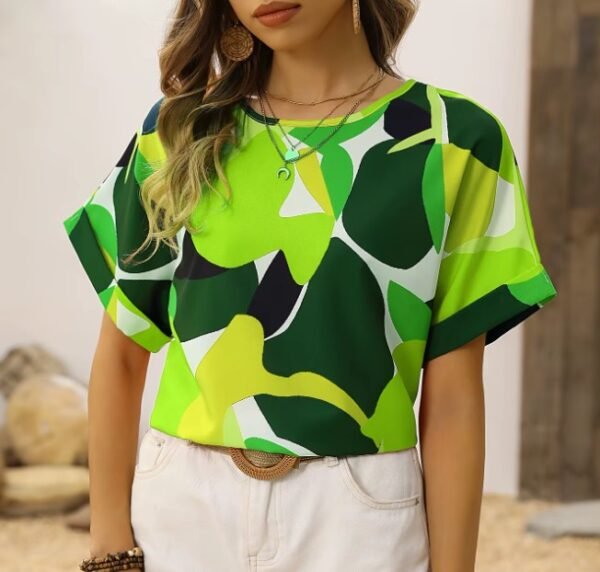 woman wearing green colorful blouse and white shorts, wooden door in the background