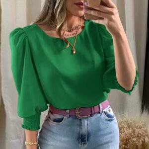 woman wearing green colorful short-sleeved blouse and jeans