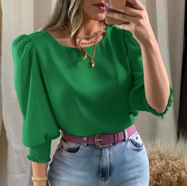 woman wearing green colorful short-sleeved blouse and jeans