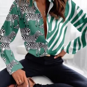 woman wearing green colorful zebra blouse and black jeans