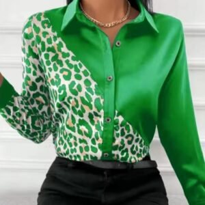 woman wearing green leopard print colorful blouse and black jeans