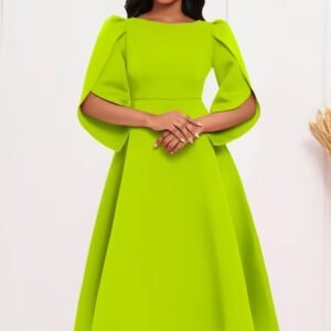 woman wearing lime green modest colorful dress and white sandals, white wall behind her