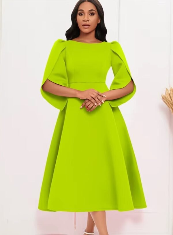 woman wearing lime green modest colorful dress and white sandals, white wall behind her