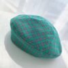 Green plaid colorful beret on the white background