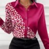 woman wearing pink leopard print colorful blouse and black jeans