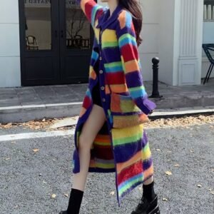 woman turned to her side wearing long colorful cardigan and black boots on the street