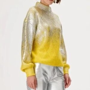 woman turned to her side wearing metallic colorful sweater and silver jeans