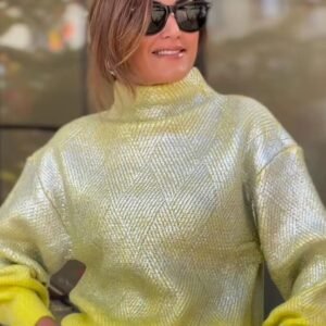 woman with brown hair wearing sunglasses and metallic colorful sweater