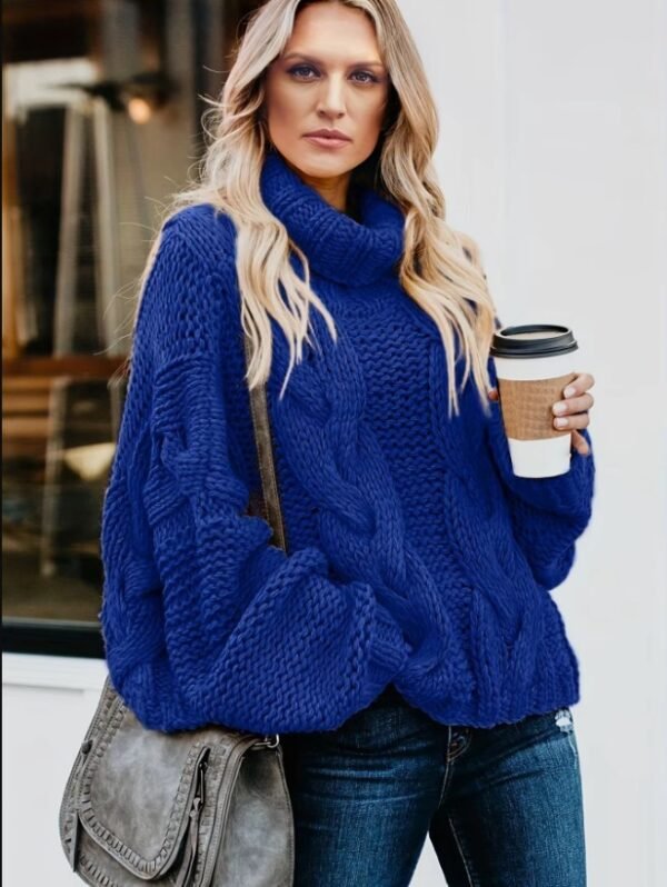 woman wearing navy blue sweater and holding a cup of coffee