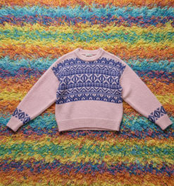 old-fashion colorful sweater on a colorful striped carpet